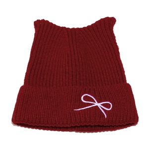 Cute burgundy knit beanie with cat ears and bow embroidery for a sweet winter look