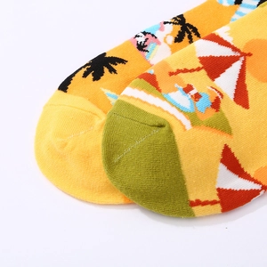 Summer themed bright yellow cotton socks with beach pattern and palm tree prints