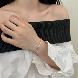 Close-up of S925 sterling silver Mobius bracelet with sparkling zircon and opal stones