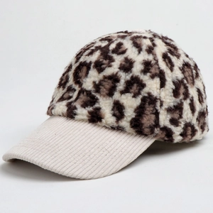 Detail of plush leopard print baseball cap with cream white corduroy brim and texture