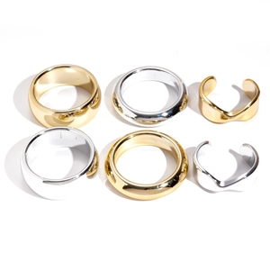 Minimalist geometric gold and silver ring set featuring polished twisted metal bands