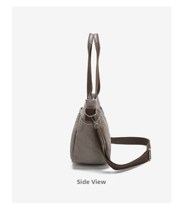 Side view of gray canvas tote bag featuring brown woven strap and durable metal D-ring hardware