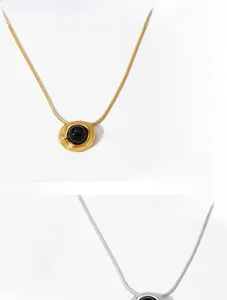 Macro shot of ripple texture gold and silver pendants with black onyx inlay