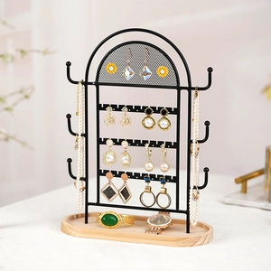 Black metal grid jewelry organizer with wood base for earrings and necklaces