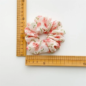 Floral chiffon scrunchie with pink flowers on off-white fabric and elastic design