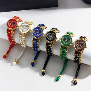 Close-up of heart-shaped rhinestone quartz watches with colorful woven rope bands