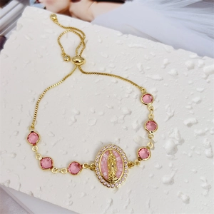 Detail of 18K gold plated Virgin Mary pendant with pink cubic zirconia on slider bracelet