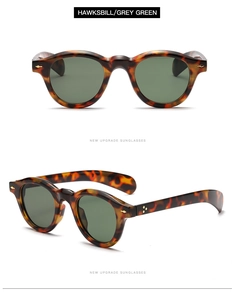 Detail of vintage round tortoiseshell sunglasses with dark green lenses and gold rivets
