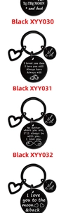Detailed view of black stainless steel keychains with engraved romantic quotes and symbols
