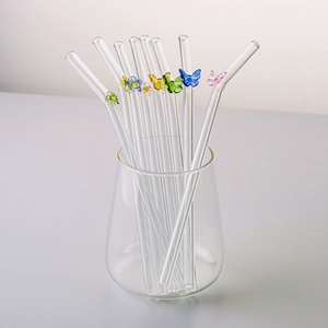 Heat-resistant glass straws set with colorful butterfly and floral ornaments in glass cup