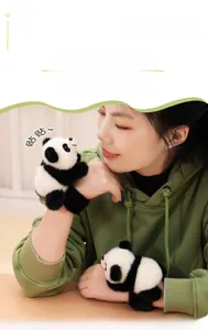 Detail of plush panda slap bracelet accessory featuring fluffy black and white faux fur