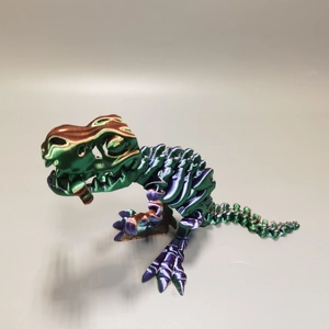 Detailed macro view of a 3D printed T-Rex skeleton with metallic iridescent finish