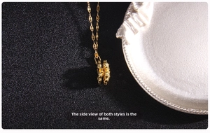 Macro view showing the layered side structure and gold-plated texture of the clover pendant