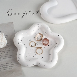 White flower shaped ceramic jewelry tray with black polka dots for rings and decor