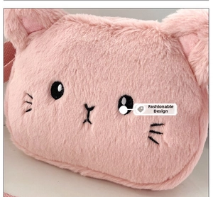 Close-up of pink plush cat shoulder bag with detailed embroidery and soft texture