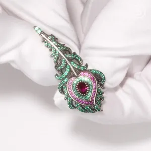 Detailed macro view of 925 silver peacock feather brooch with inlaid colorful zircons