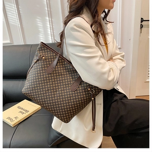 Model posing with a large vintage geometric print tote bag in dark brown faux leather