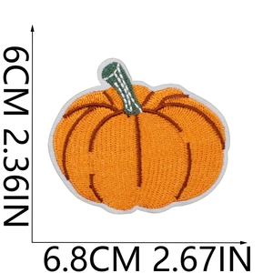 Detailed macro view showing dimensions of orange pumpkin embroidery patch with size markers