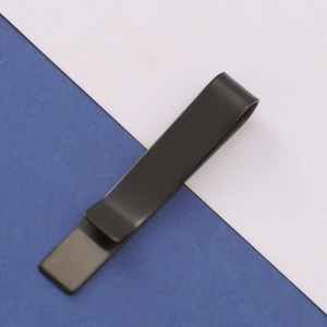 Detailed view of a sleek matte black metal tie clip on a minimalist blue and white background
