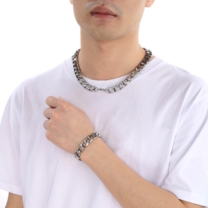 Men's silver polished stainless steel Cuban link necklace and bracelet set on model