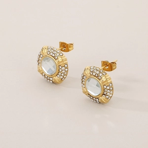 Detail view of 18k gold oval stud earrings with clear center stone and micro-pavé crystals