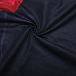 Close-up of black floral fabric with red print and purple lines for summer crop tops