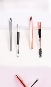 Detailed view of silver flat brush and rose gold lash wand with metal caps and non-slip grips