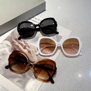 Detailed view of fashion sunglasses in black, pearl white, and tortoiseshell frames