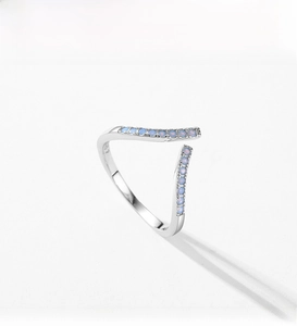 Macro shot of V-shaped S925 silver ring with inlaid light blue cubic zirconia stones