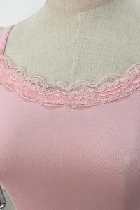 Detail of pink knitted camisole showing floral lace trim and fine ribbed texture
