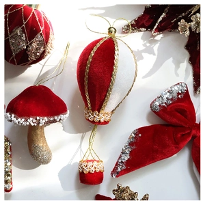 Detail of velvet Christmas ornaments with red sequins and gold embroidery