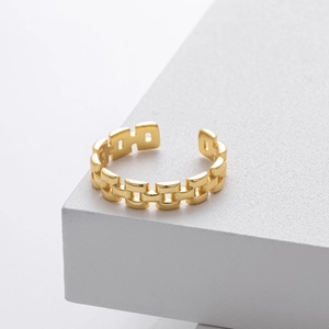 Close-up of S925 hallmark on vintage chain ring displayed on a white geometric platform