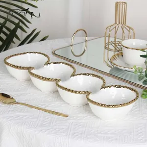 Close-up of white ceramic 4-section appetizer tray with elegant gold beaded rim detail