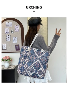 Detail of bohemian geometric woven tote bag featuring soft cotton rope knotted handles