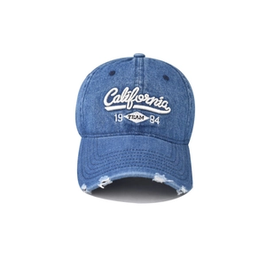Close-up of distressed brim details on washed denim California baseball cap