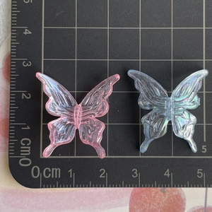 Top view of 3cm transparent pink and blue acrylic butterfly charms for DIY jewelry making