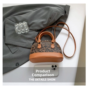 Detailed top view of leopard print shell bag with brown leather accents and gold hardware