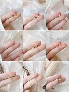 Nine-piece set of minimalist gold stud earrings featuring cactus, pearl, and animal designs