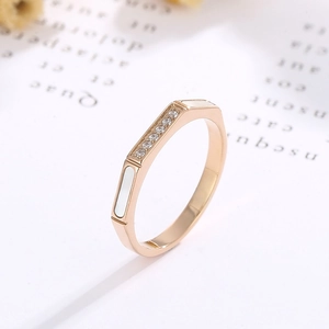 Detailed macro of rose gold octagonal ring with shell inlay and micro-pave zircons