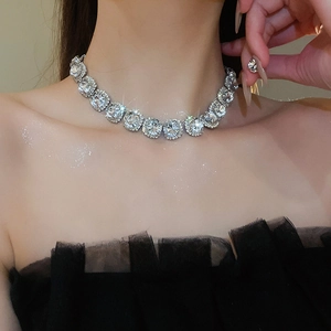 Close-up of sparkling rhinestone choker and matching earrings on a model's neck