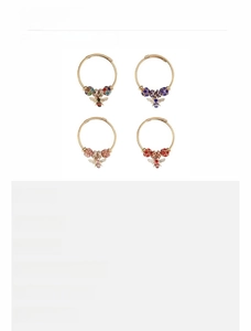 Detail view of colorful zircon bee pendants on gold finish rings in various sizes