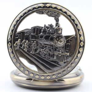 Macro detail of bronze quartz pocket watch featuring embossed vintage train design
