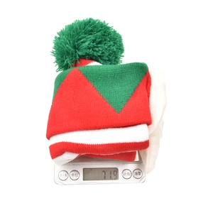 Elf style Christmas knit hat with red and green stripes and a large green pom-pom