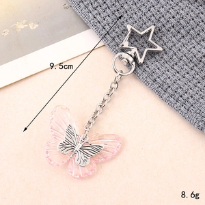 Detailed view of pink resin butterfly keychain with star clasp, 9.5cm length and 8.6g weight