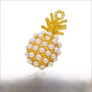 Detailed view of pineapple pendant with brass base and white faux pearls, 9x16.5mm size