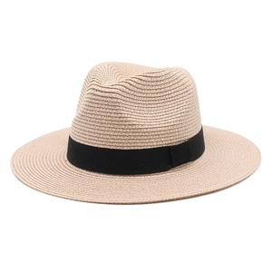 Close-up of fine straw weave and black ribbon detail on a beige Fedora sun hat