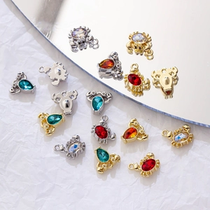 Detailed view of gold and silver crab charms with colorful rhinestones for jewelry making