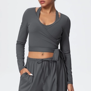 Detail of dark grey yoga wrap top with stylish tie-waist and matching racerback tank