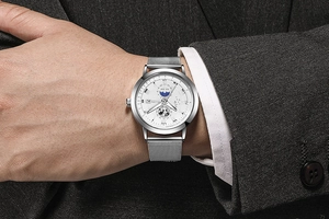 Macro shot of a men's business quartz watch with silver mesh band and world map dial