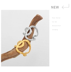 Detail of twisted rope texture and polished 18K gold plating on irregular open rings